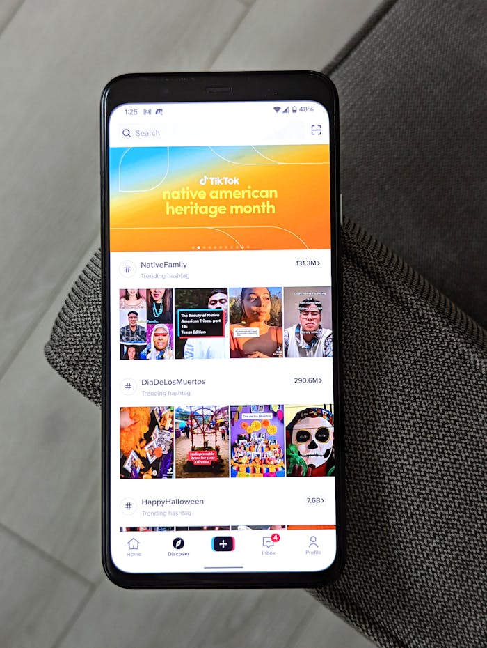 hero-img-02 A smartphone showing TikTok trends for Native American Heritage Month, Dia De Los Muertos, and Halloween.